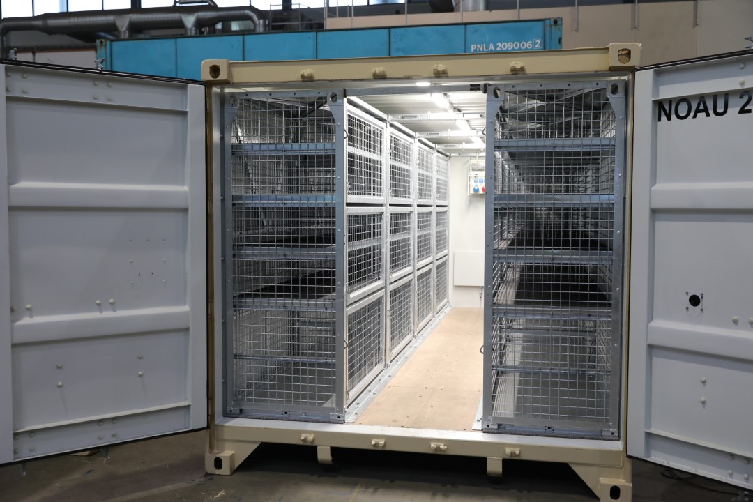 20ft container outfitted with SHARKCAGEs — mobile cages with shelves.