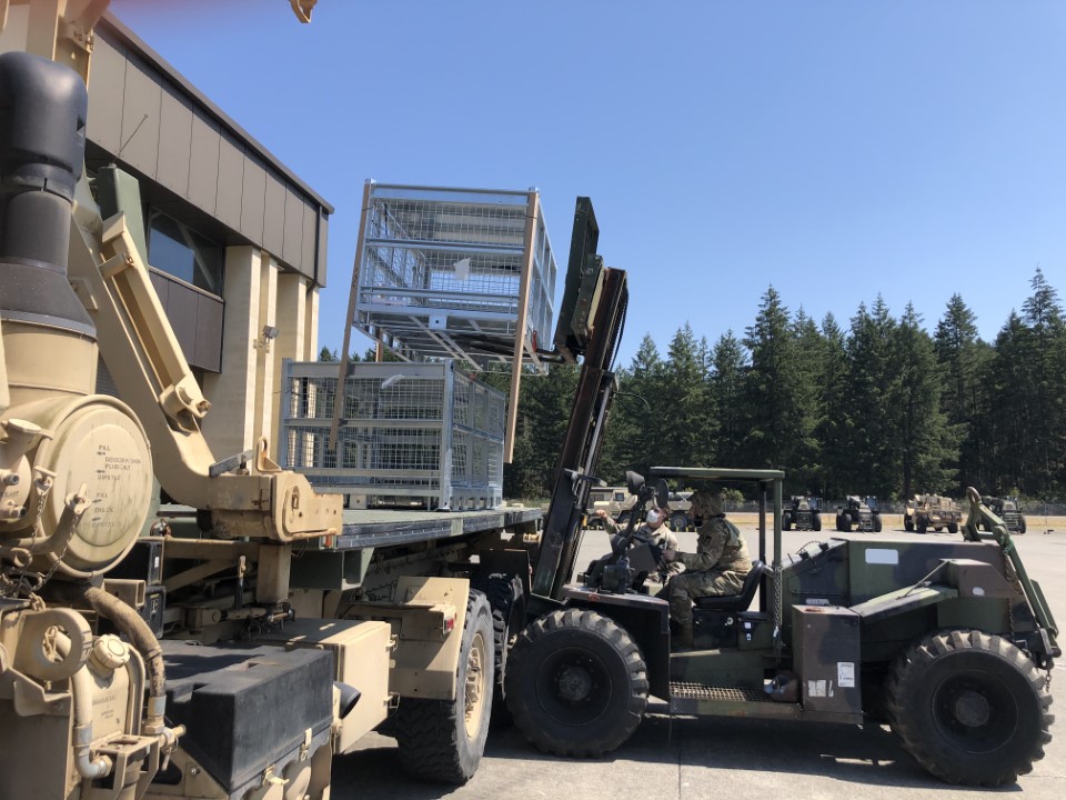 SHARKCAGE Tactical Basket XL being loaded on a flatbed by a forklift.